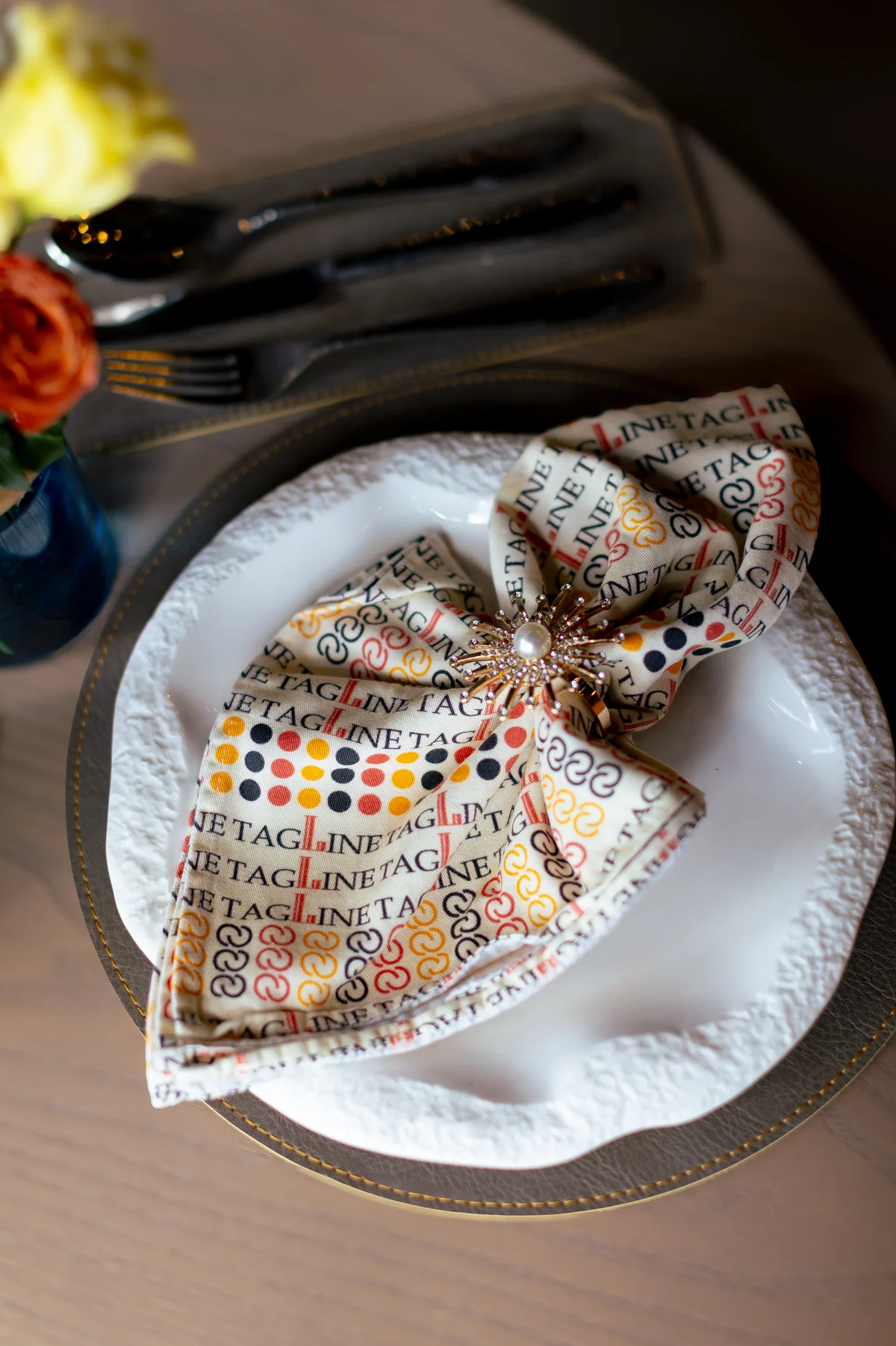 A patterned napkin and place setting at Tagline