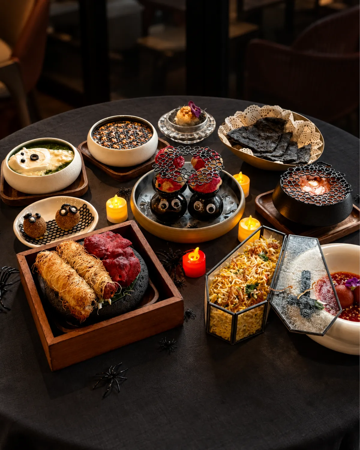 The full Halloween set menu from above, with biryani in a glass coffin box and gulab jamun
