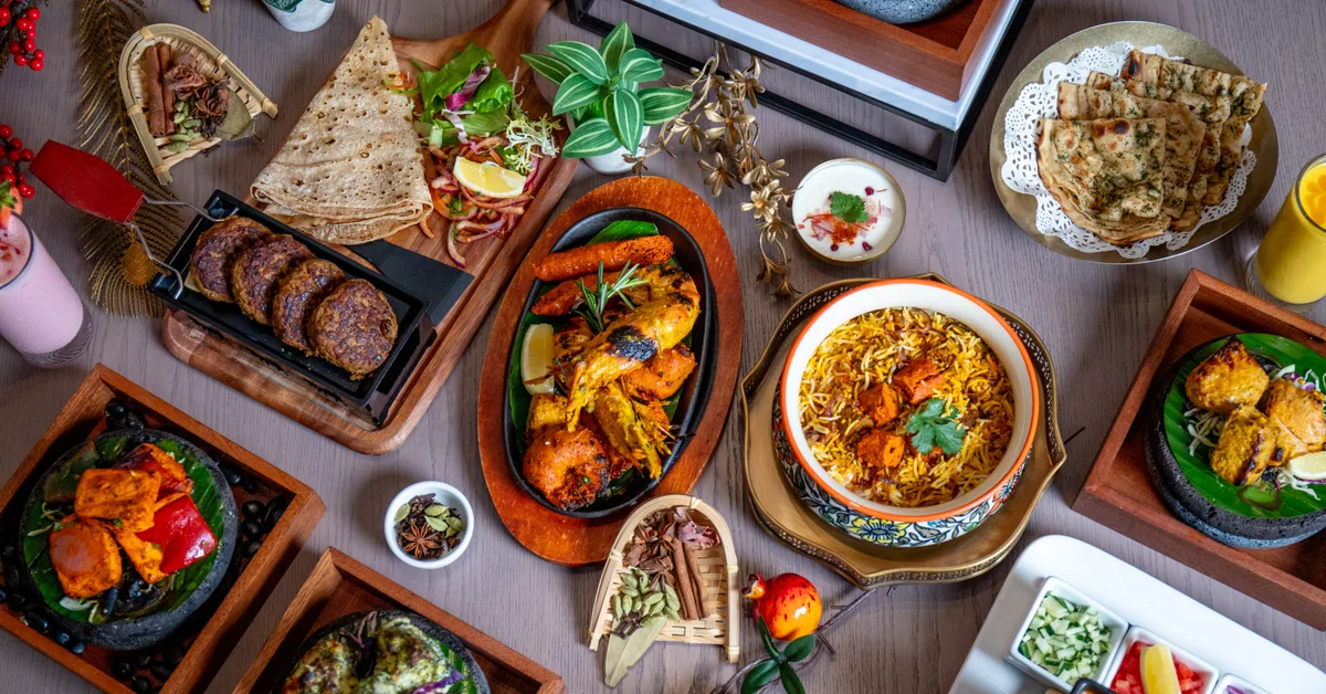 An overhead table of sizzlers, curries, biryani and breads