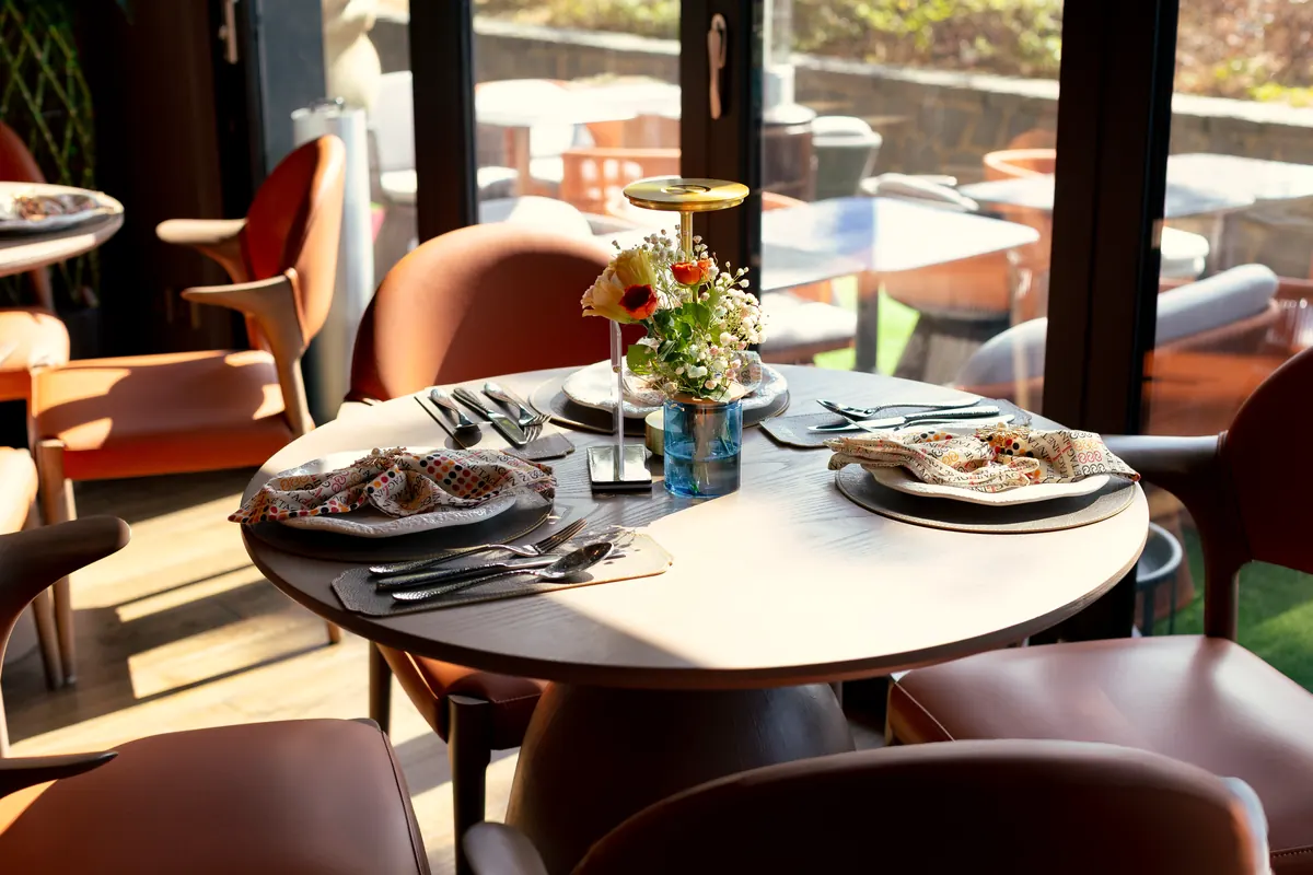 A round table set for lunch on Tagline’s ground-floor patio